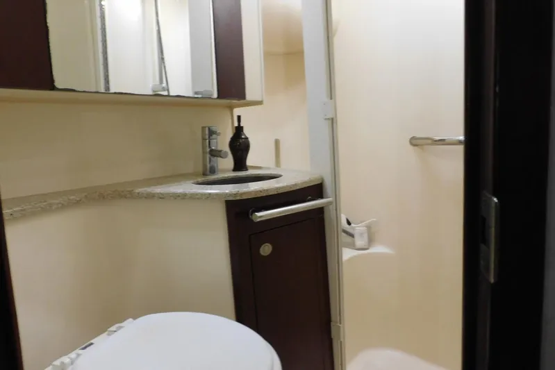 Full Deck Yacht Photos Pics Bathroom interior of 2008 Sea Ray 44 Sedan Bridge yacht, featuring sink and shower.