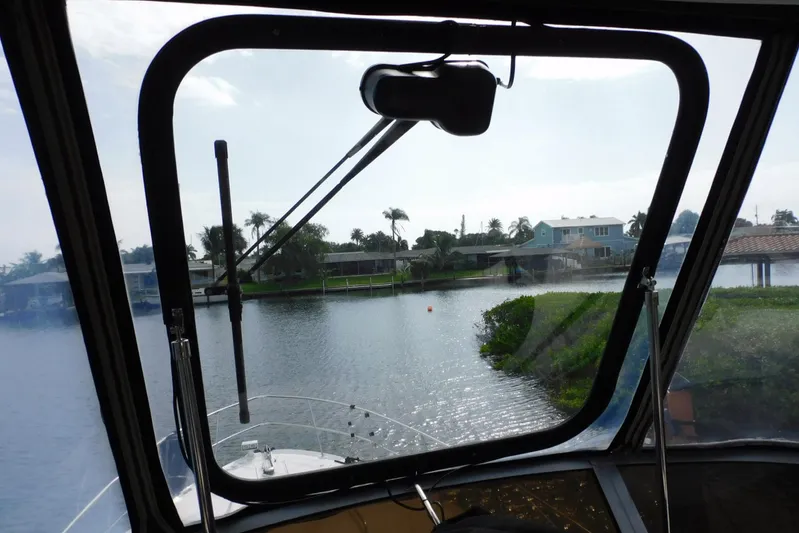 Full Deck Yacht Photos Pics View from 2008 Sea Ray 44 Sedan Bridge, overlooking serene waterfront homes.