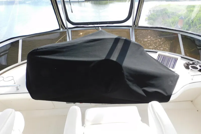 Full Deck Yacht Photos Pics 2008 Sea Ray 44 Sedan Bridge helm covered, overlooking water through windshield.