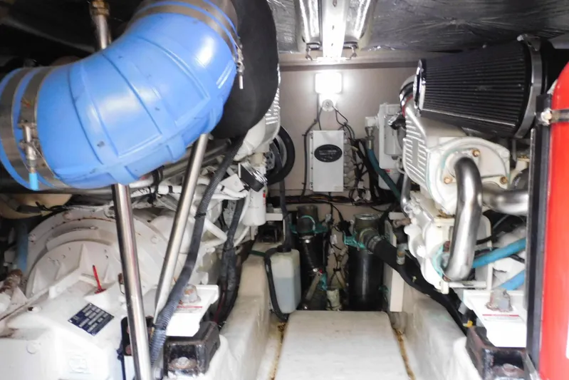 Full Deck Yacht Photos Pics Engine room of 2008 Sea Ray 44 Sedan Bridge with visible components and blue piping.