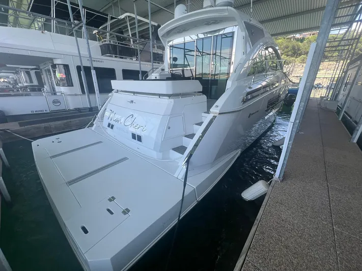 Mon Cheri Yacht Photos Pics 2018 Cruisers Yachts 54 Cantius docked in a marina under a covered area.