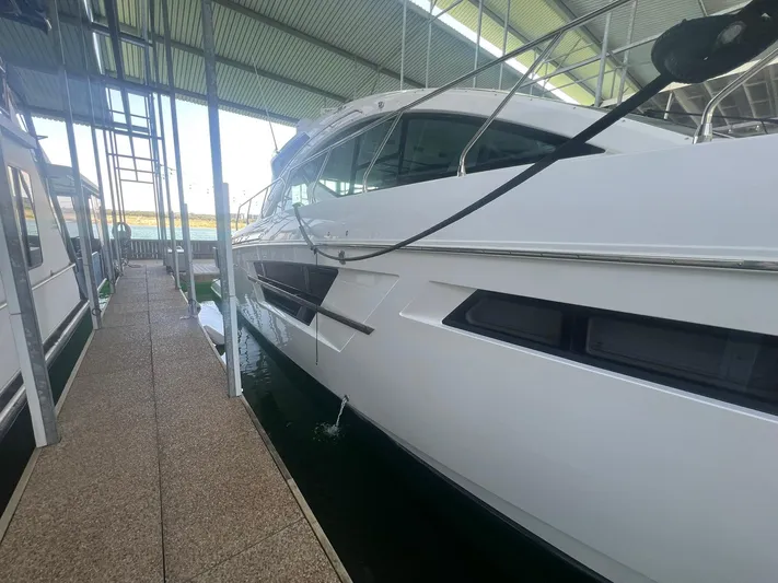 Mon Cheri Yacht Photos Pics 2018 Cruisers Yachts 54 Cantius docked in a covered marina.