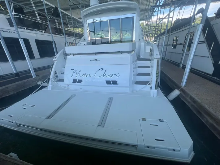 Mon Cheri Yacht Photos Pics 2018 Cruisers Yachts 54 Cantius docked, rear view with "Mon Cheri" name visible.