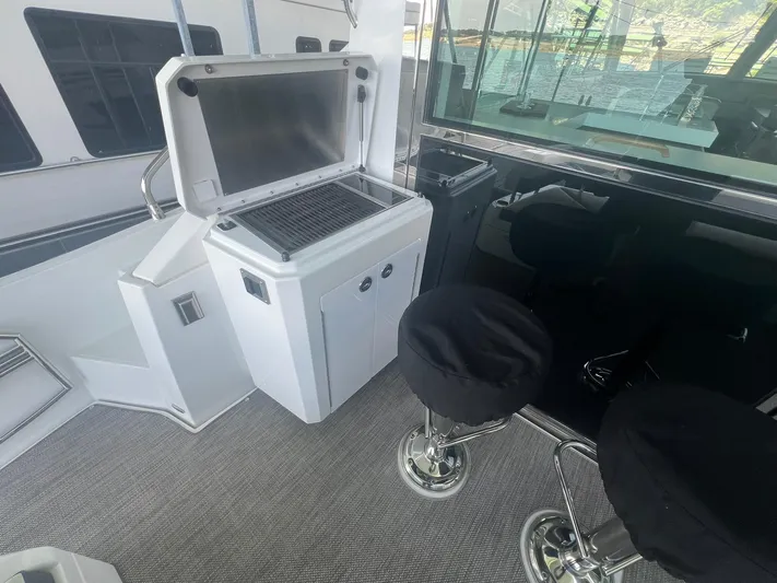 Mon Cheri Yacht Photos Pics 2018 Cruisers Yachts 54 Cantius interior with grill and bar stools.