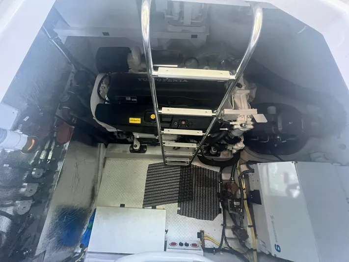 Mon Cheri Yacht Photos Pics Engine room of 2018 Cruisers Yachts 54 Cantius with visible machinery and ladder.