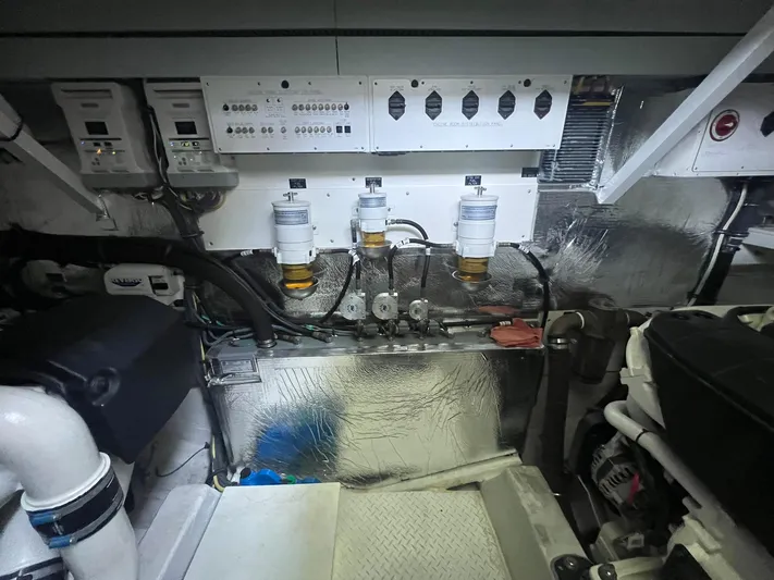 Mon Cheri Yacht Photos Pics Engine room of 2018 Cruisers Yachts 54 Cantius with control panels and filters.