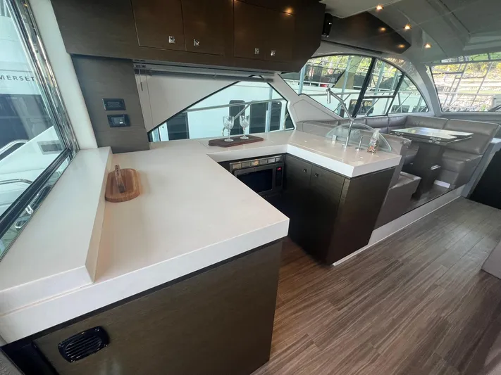 Mon Cheri Yacht Photos Pics Interior of 2018 Cruisers Yachts 54 Cantius with modern kitchen and sleek design.