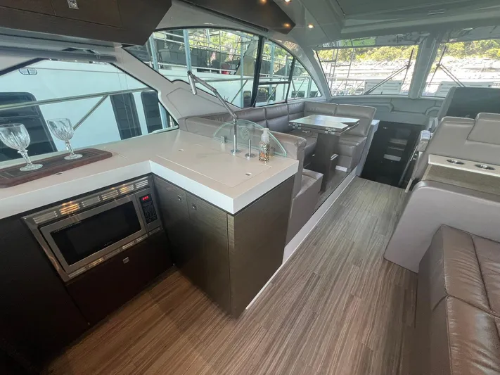 Mon Cheri Yacht Photos Pics 2018 Cruisers Yachts 54 Cantius interior with modern kitchen and seating area.