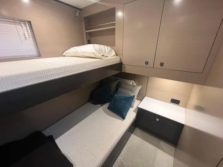 Mon Cheri Yacht Photos Pics 2018 Cruisers Yachts 54 Cantius cabin with bunk beds and modern storage.