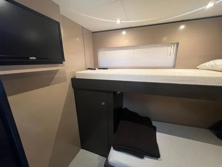 Mon Cheri Yacht Photos Pics Interior cabin of 2018 Cruisers Yachts 54 Cantius with bunk beds and TV.