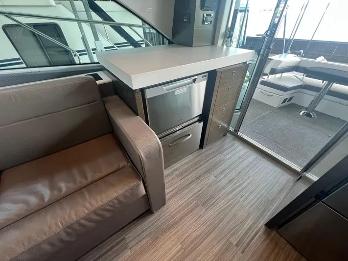 Mon Cheri Yacht Photos Pics Interior of 2018 Cruisers Yachts 54 Cantius with modern seating and kitchenette.