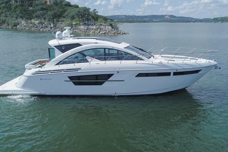 Mon Cheri Yacht Photos Pics 2018 Cruisers Yachts 54 Cantius on serene lake with scenic background.