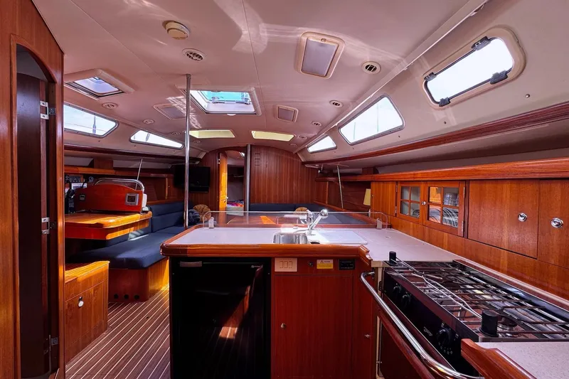  Yacht Photos Pics Interior of 2006 Hunter 38 sailboat with wood finish and modern amenities.