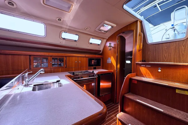  Yacht Photos Pics Luxurious 2006 Hunter 38 yacht interior with modern kitchen and wooden cabinetry.