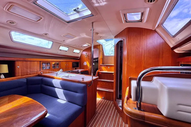  Yacht Photos Pics Luxurious interior of a 2006 Hunter 38 sailboat with wood finishes and skylights.