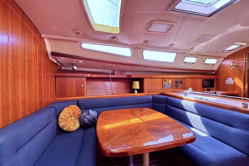 Yacht Photos Pics Luxurious interior of a 2006 Hunter 38 yacht with elegant wood finish and plush seating.
