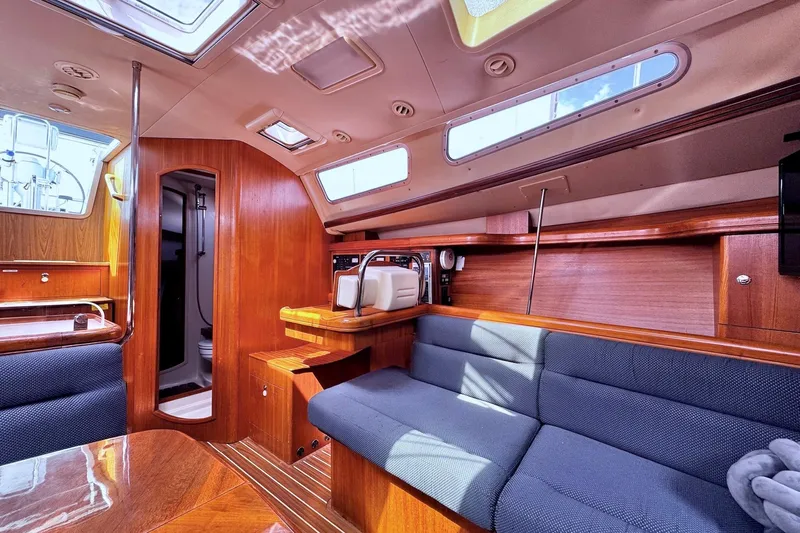  Yacht Photos Pics Luxurious interior of a 2006 Hunter 38 sailboat with wood finish and seating area.