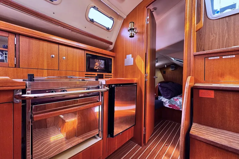  Yacht Photos Pics Interior of 2006 Hunter 38 sailboat featuring a cozy kitchen and cabin area.