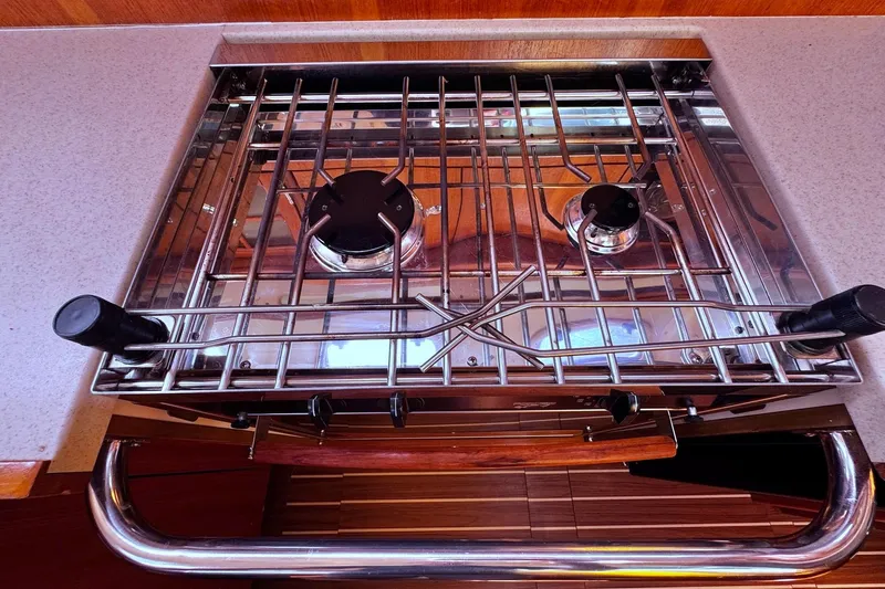  Yacht Photos Pics Stainless steel stove on a 2006 Hunter 38 yacht, featuring dual burners and safety rail.