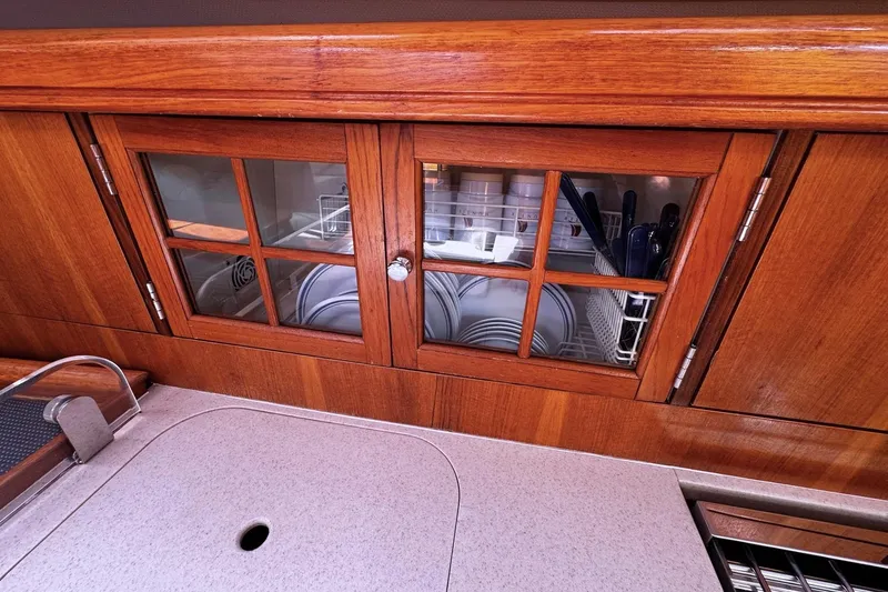  Yacht Photos Pics Wooden cabinet with glass doors in a 2006 Hunter 38 yacht kitchen.
