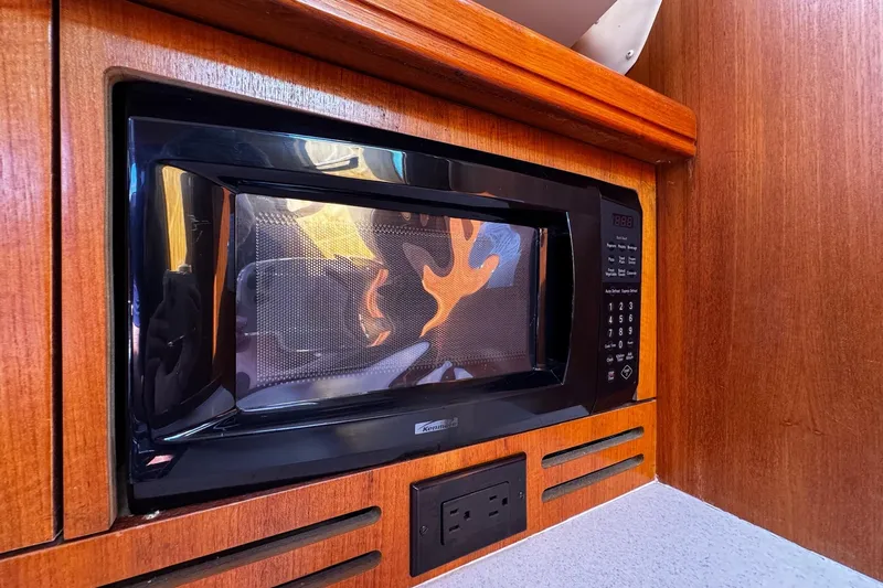  Yacht Photos Pics Microwave in 2006 Hunter 38 yacht kitchen with wooden cabinetry.