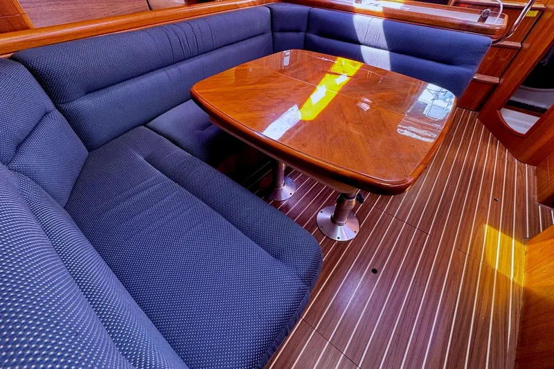  Yacht Photos Pics Luxurious interior of 2006 Hunter 38 yacht with wooden table and cushioned seating.