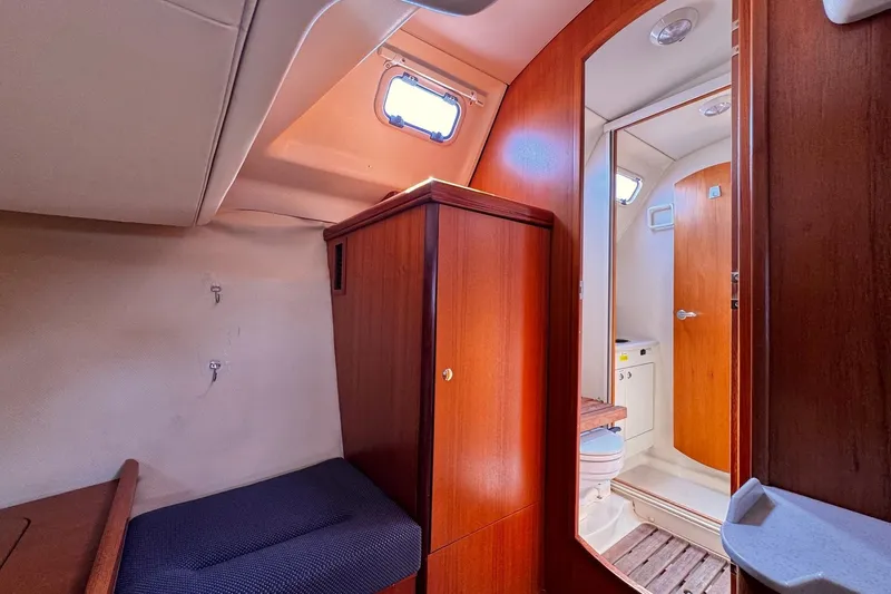  Yacht Photos Pics 2006 Hunter 38 yacht interior with wooden cabinetry and compact bathroom.