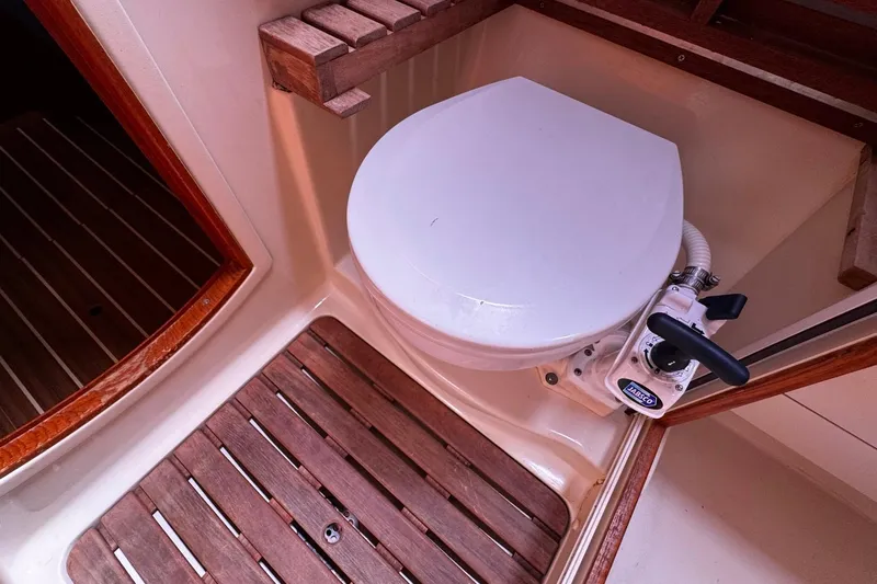  Yacht Photos Pics 2006 Hunter 38 yacht bathroom with wooden flooring and marine toilet.