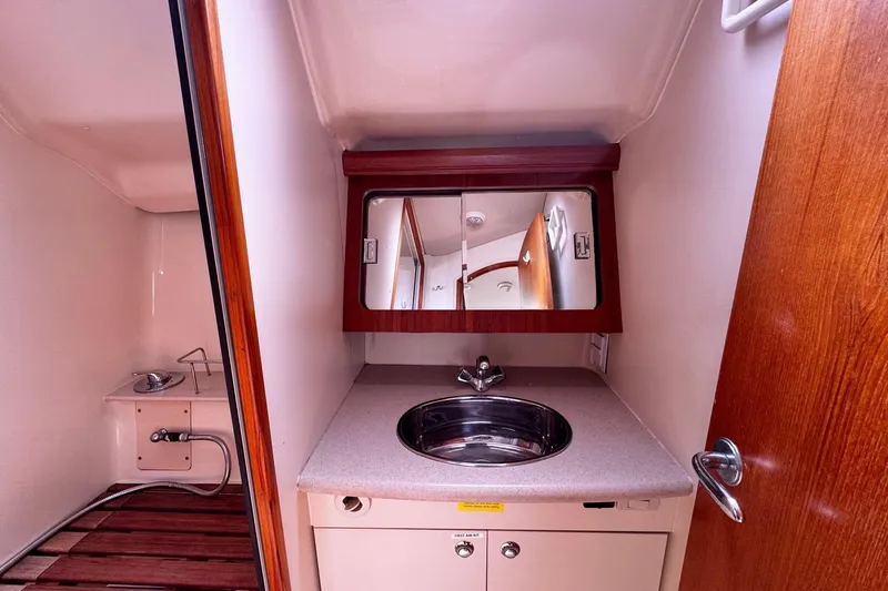  Yacht Photos Pics 2006 Hunter 38 yacht bathroom with sink, mirror, and shower area.