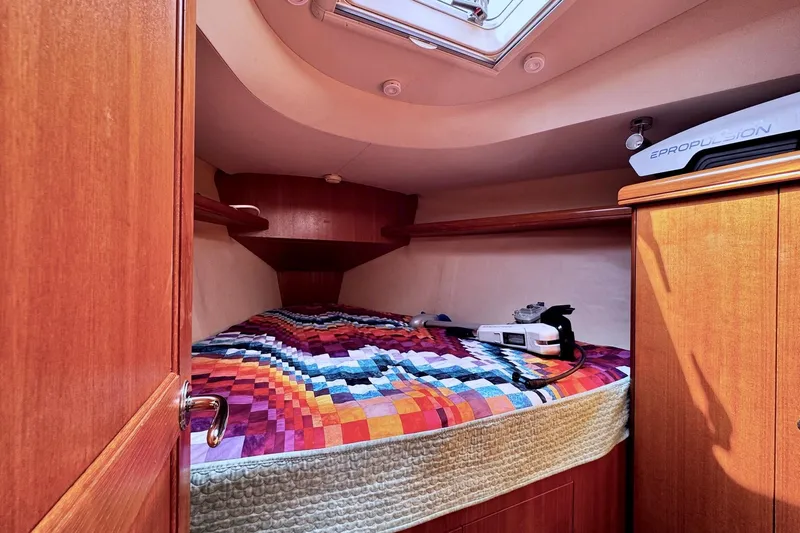  Yacht Photos Pics Cozy cabin interior of 2006 Hunter 38 sailboat with colorful quilted bedspread.