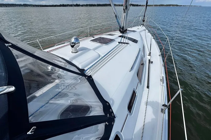  Yacht Photos Pics 2006 Hunter 38 sailboat on calm water, showcasing deck and rigging.