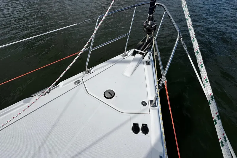  Yacht Photos Pics Bow of 2006 Hunter 38 sailboat with ropes and railing on water.