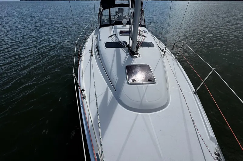  Yacht Photos Pics 2006 Hunter 38 sailboat on calm water, showcasing sleek deck design and rigging.