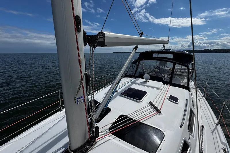  Yacht Photos Pics Sailing on a 2006 Hunter 38 yacht, clear skies, calm waters, and visible rigging.