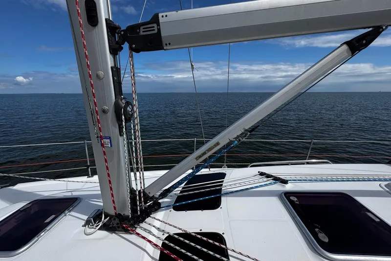  Yacht Photos Pics Sailboat deck view on a 2006 Hunter 38, featuring rigging and ocean backdrop.