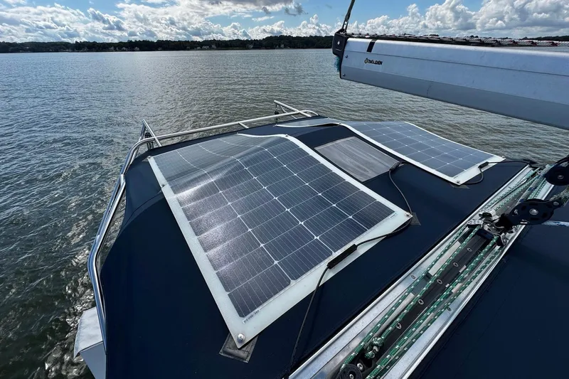  Yacht Photos Pics Hunter 38 sailboat with solar panels on deck, 2006 model, on a calm lake.