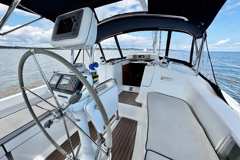  Yacht Photos Pics Cockpit of 2006 Hunter 38 sailboat with steering wheel and navigation equipment.