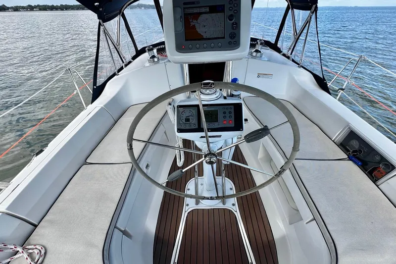  Yacht Photos Pics Steering wheel and navigation equipment on a 2006 Hunter 38 sailboat deck.