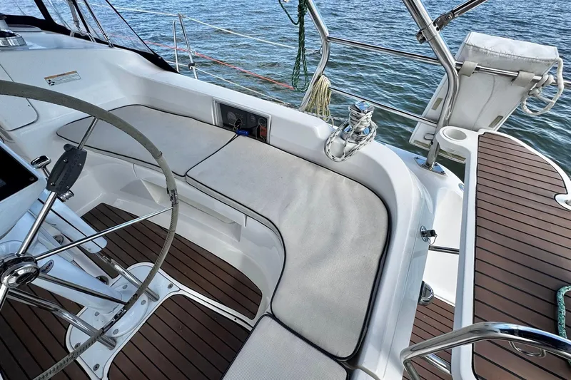  Yacht Photos Pics 2006 Hunter 38 sailboat cockpit with steering wheel and cushioned seating.