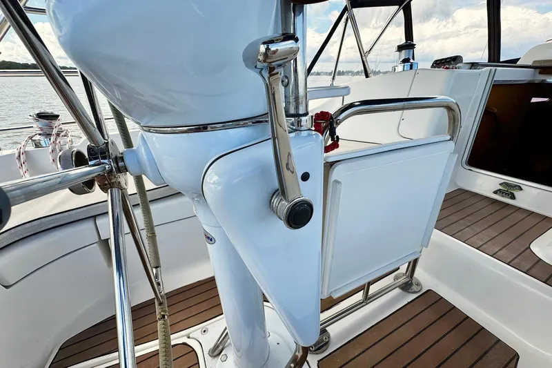  Yacht Photos Pics 2006 Hunter 38 yacht cockpit with steering wheel and wooden flooring.