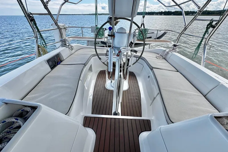  Yacht Photos Pics Spacious cockpit of 2006 Hunter 38 sailboat with comfortable seating and scenic water view.