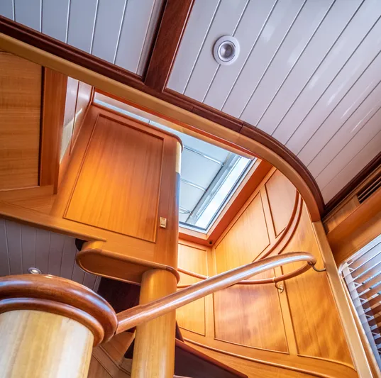 Fortuna Yacht Photos Pics Interior of 1999 Palmer Johnson Motor Yacht with wooden staircase and ceiling details.