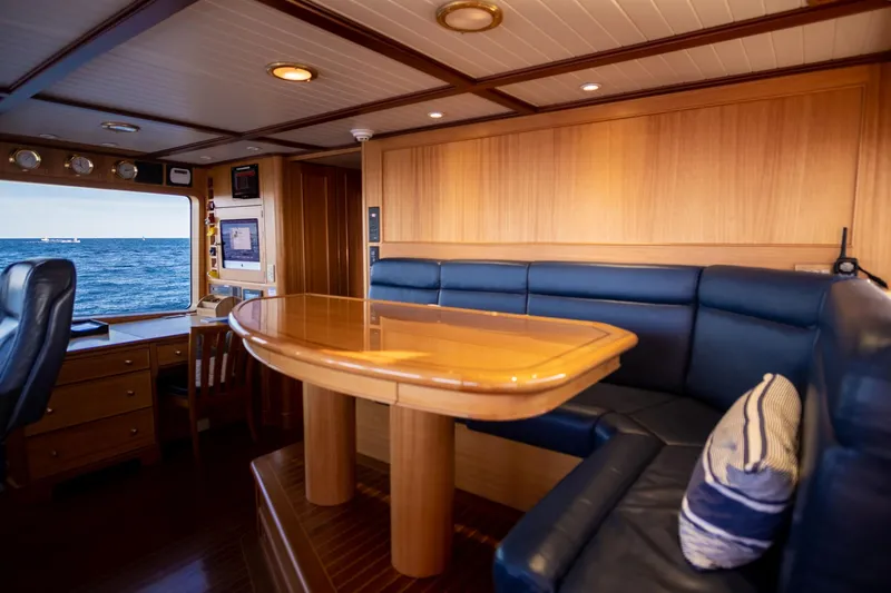 Fortuna Yacht Photos Pics Luxurious 1999 Palmer Johnson motor yacht interior with wood paneling and ocean view.