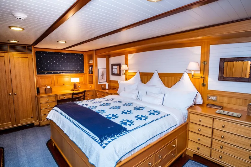 Fortuna Yacht Photos Pics Luxurious cabin interior of a 1999 Palmer Johnson Motor Yacht with wooden furnishings.