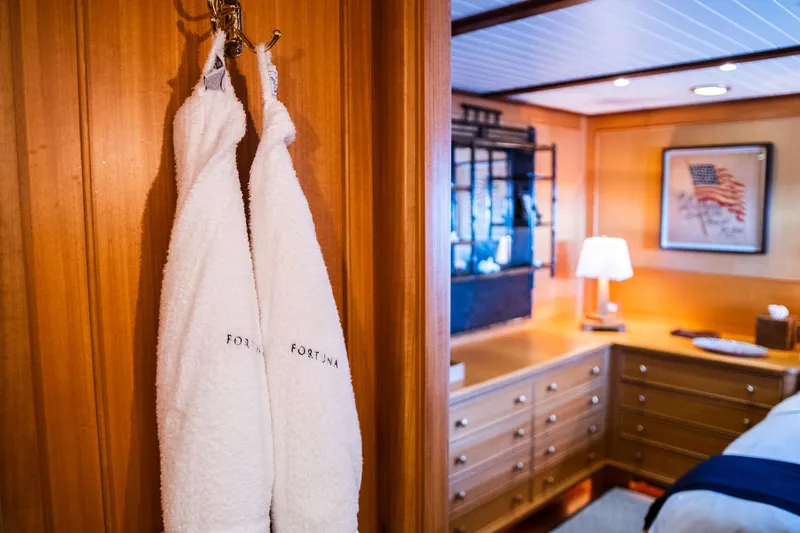 Fortuna Yacht Photos Pics Luxurious cabin interior of 1999 Palmer Johnson motor yacht with robes and elegant decor.