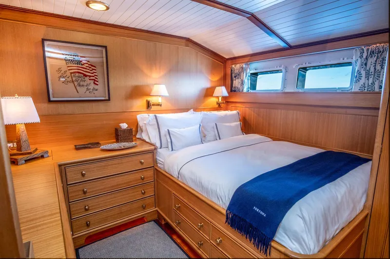 Fortuna Yacht Photos Pics Luxurious 1999 Palmer Johnson motor yacht bedroom with elegant wood paneling and cozy bedding.