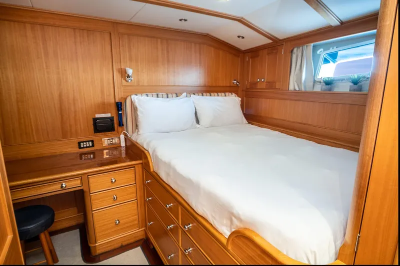 Fortuna Yacht Photos Pics Luxurious wood-paneled bedroom in a 1999 Palmer Johnson motor yacht.