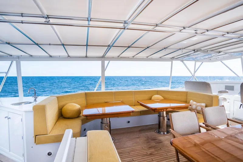 Fortuna Yacht Photos Pics Luxurious Palmer Johnson 1999 motor yacht deck with seating, tables, and ocean view.