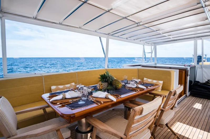 Fortuna Yacht Photos Pics Luxurious dining area on 1999 Palmer Johnson motor yacht with ocean view.