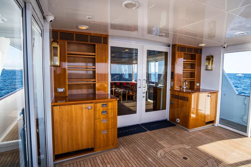 Fortuna Yacht Photos Pics Luxurious 1999 Palmer Johnson motor yacht interior with wooden cabinetry and ocean view.